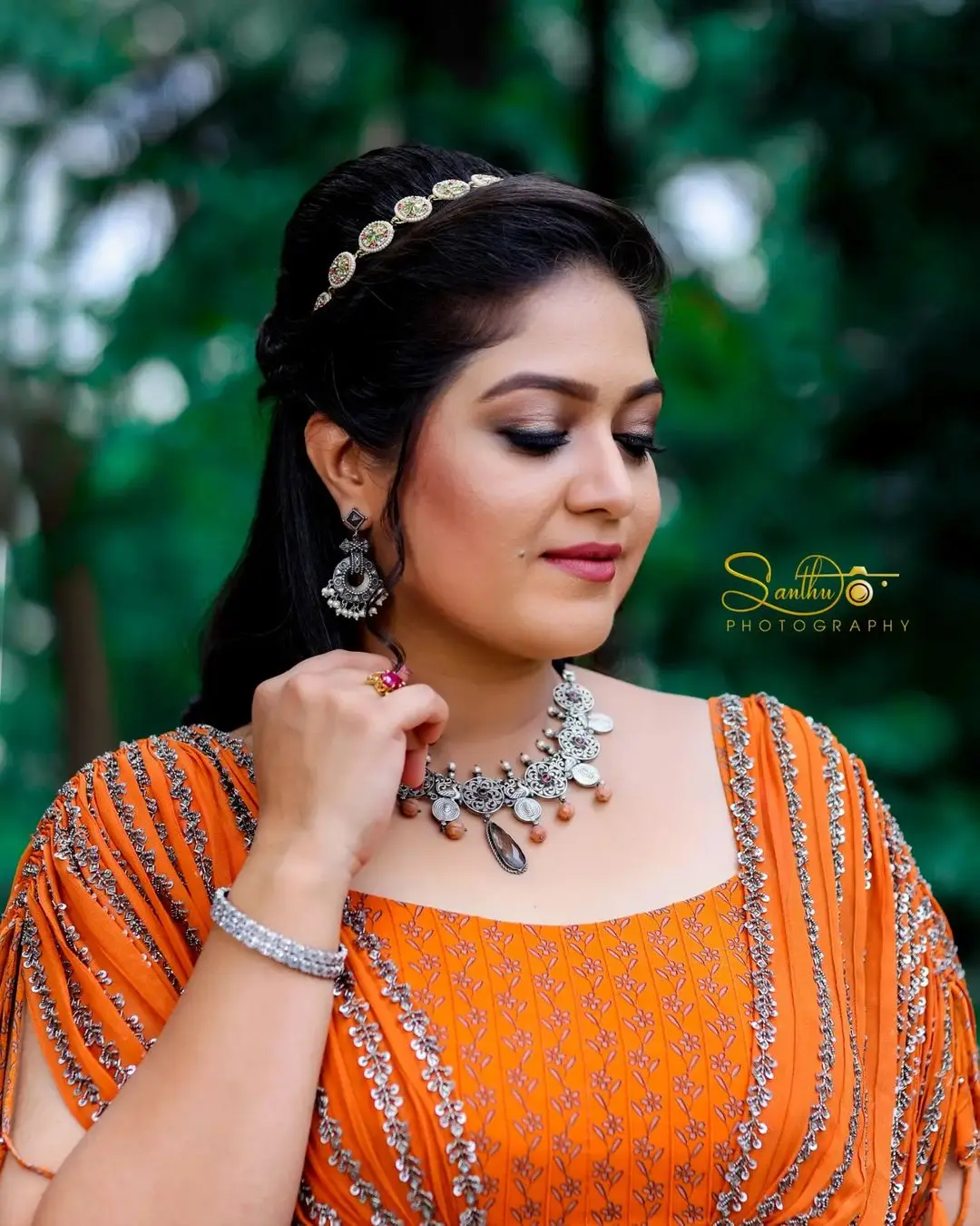 Meghana Raj Wearing Beautiful Earring Jewellery Orange Gown